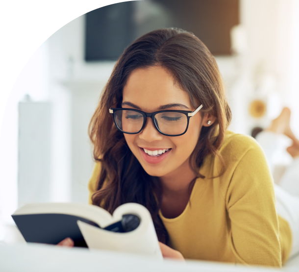 Woman in glasses reading a book.